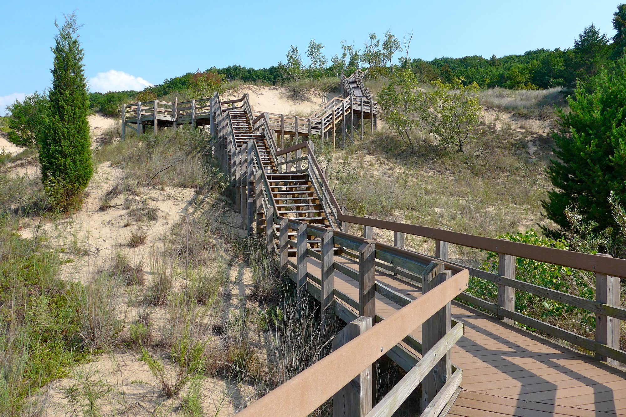 A wood boardwalk leads to the shores of Lake Michigan at the Dunewood Campgrounds in indiana