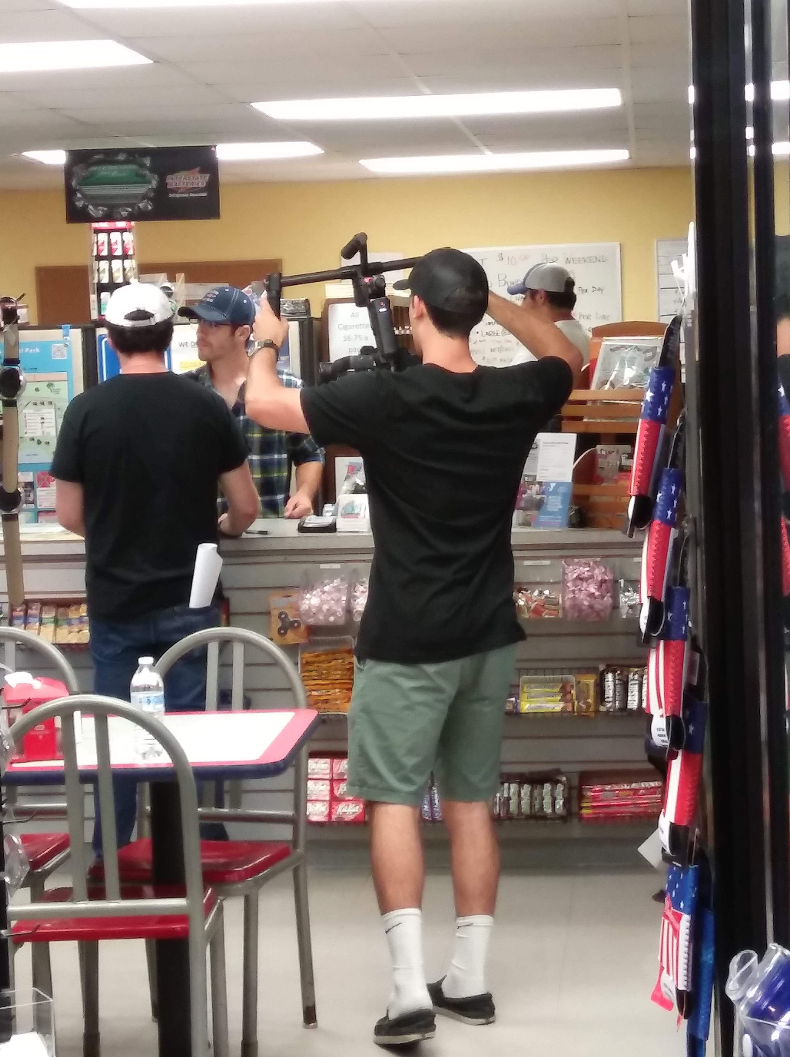 Student film crew filming in the store.