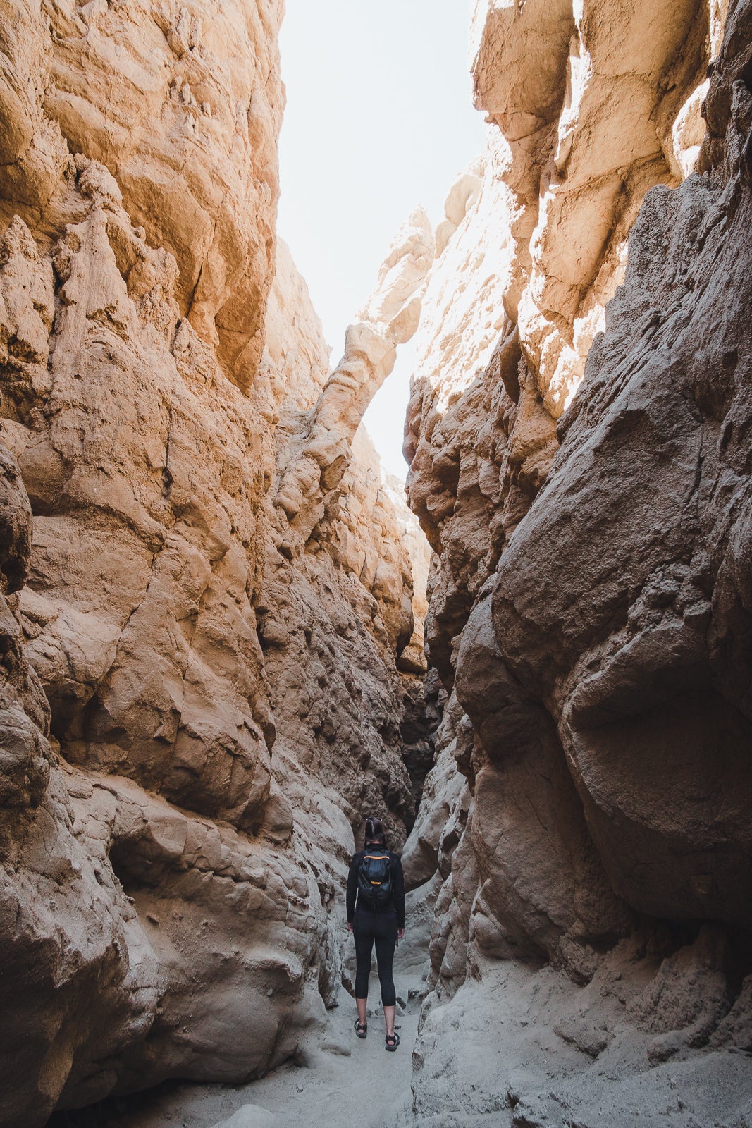 female hiker making her way through the Slot hike in Anza-Borrego Desert State Park