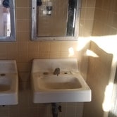 men's room had a flushing toilet but the sinks had no running water