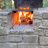 Fire burning in campsite fireplace