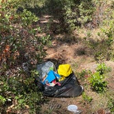 bag of trash behind camp site