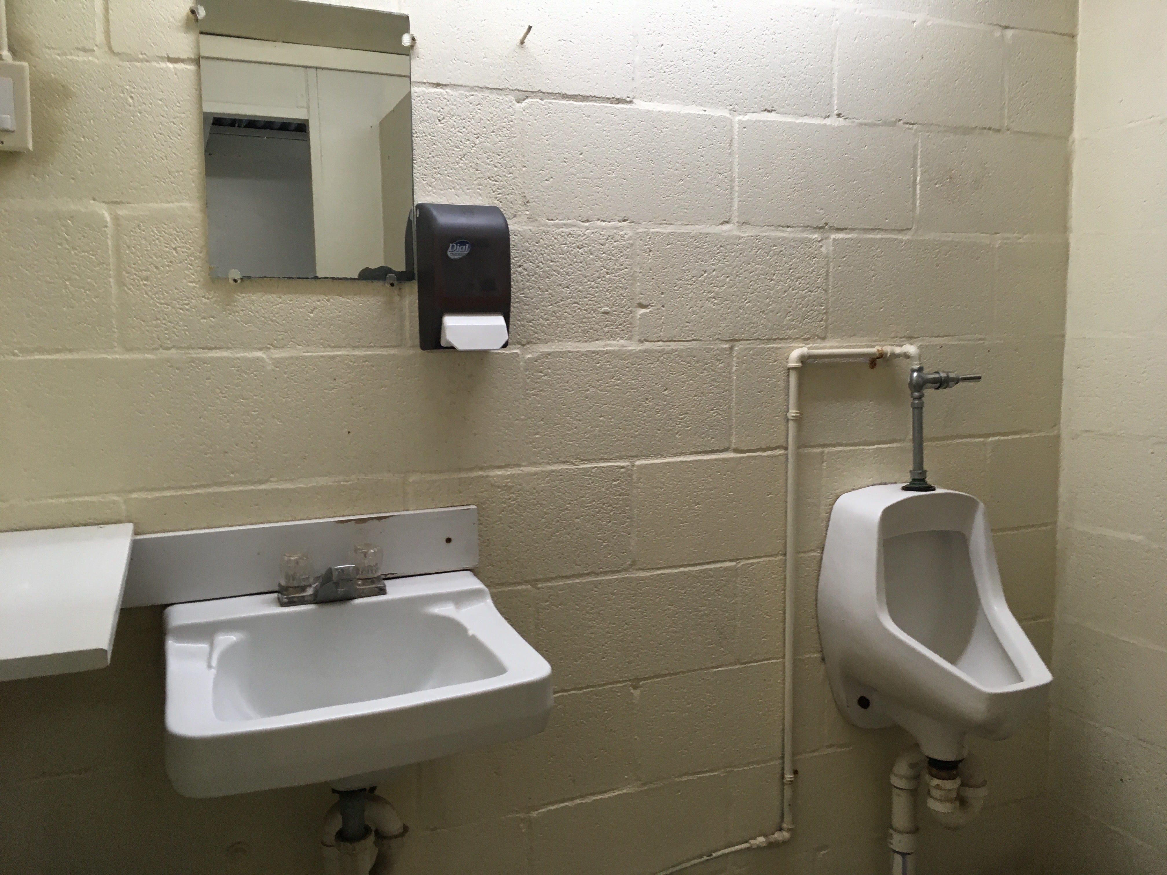 The restrooms offer basic sinks and toilets