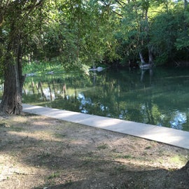 A sidewalk with stair allows easy access to the river