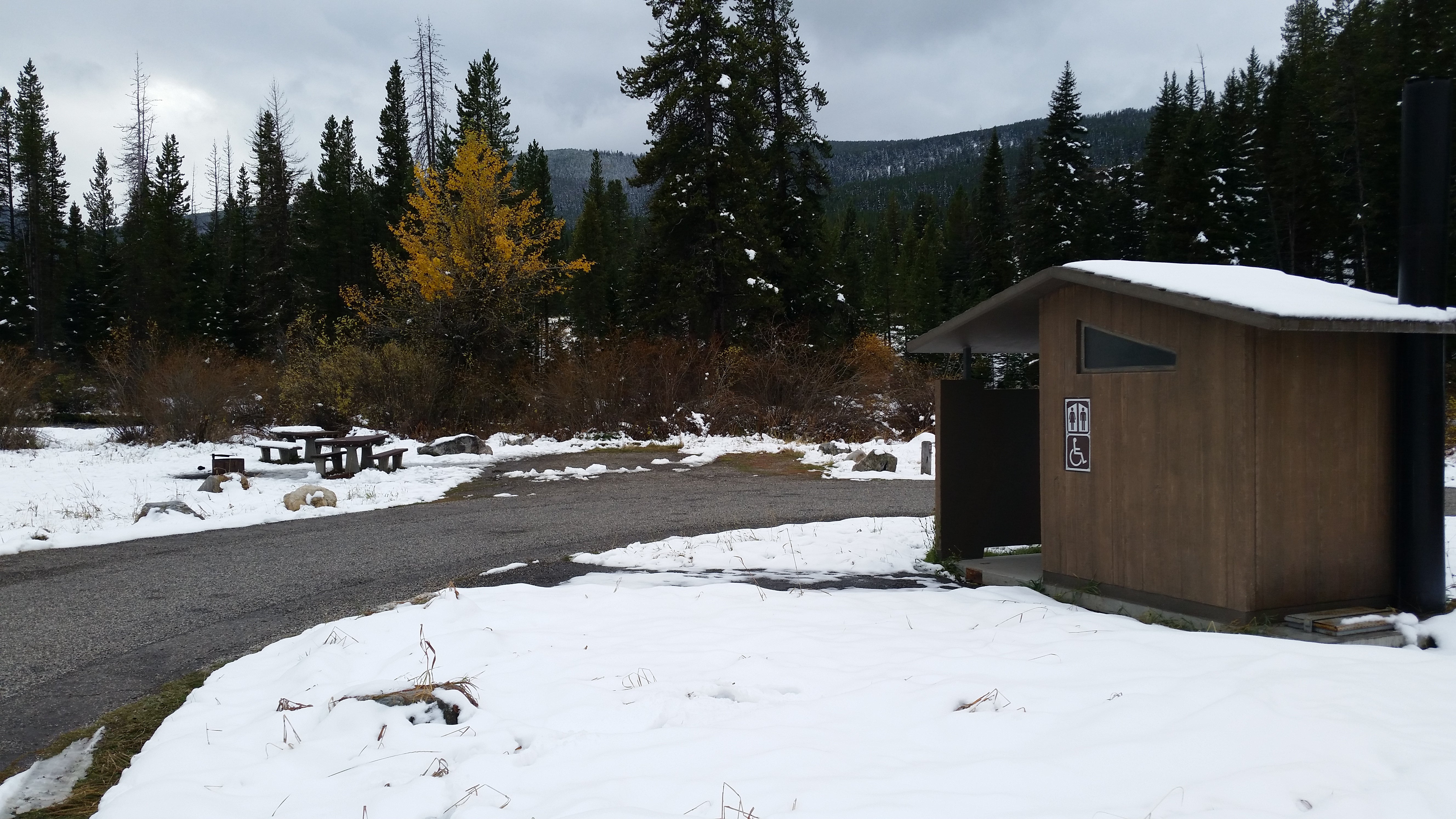 Vault toilet and site 17 with two picnic tables