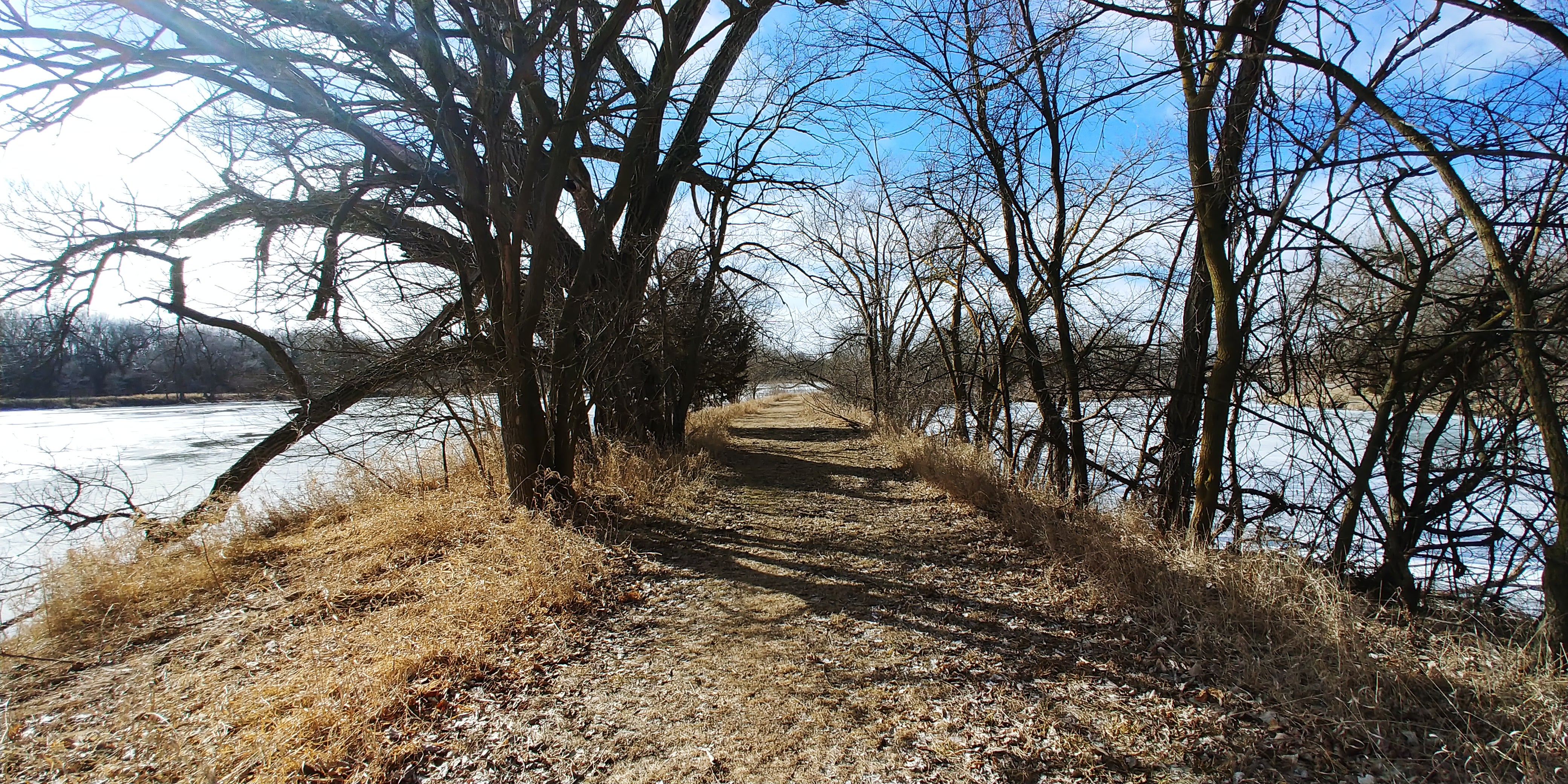 Path between ponds and river
