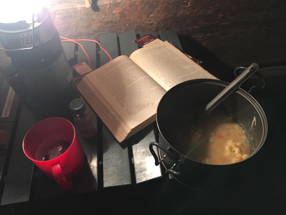 My exciting weekend night: a pot of something hot & gooey, a good book, and a beer, all by lantern light