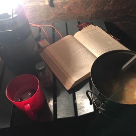 My exciting weekend night: a pot of something hot & gooey, a good book, and a beer, all by lantern light