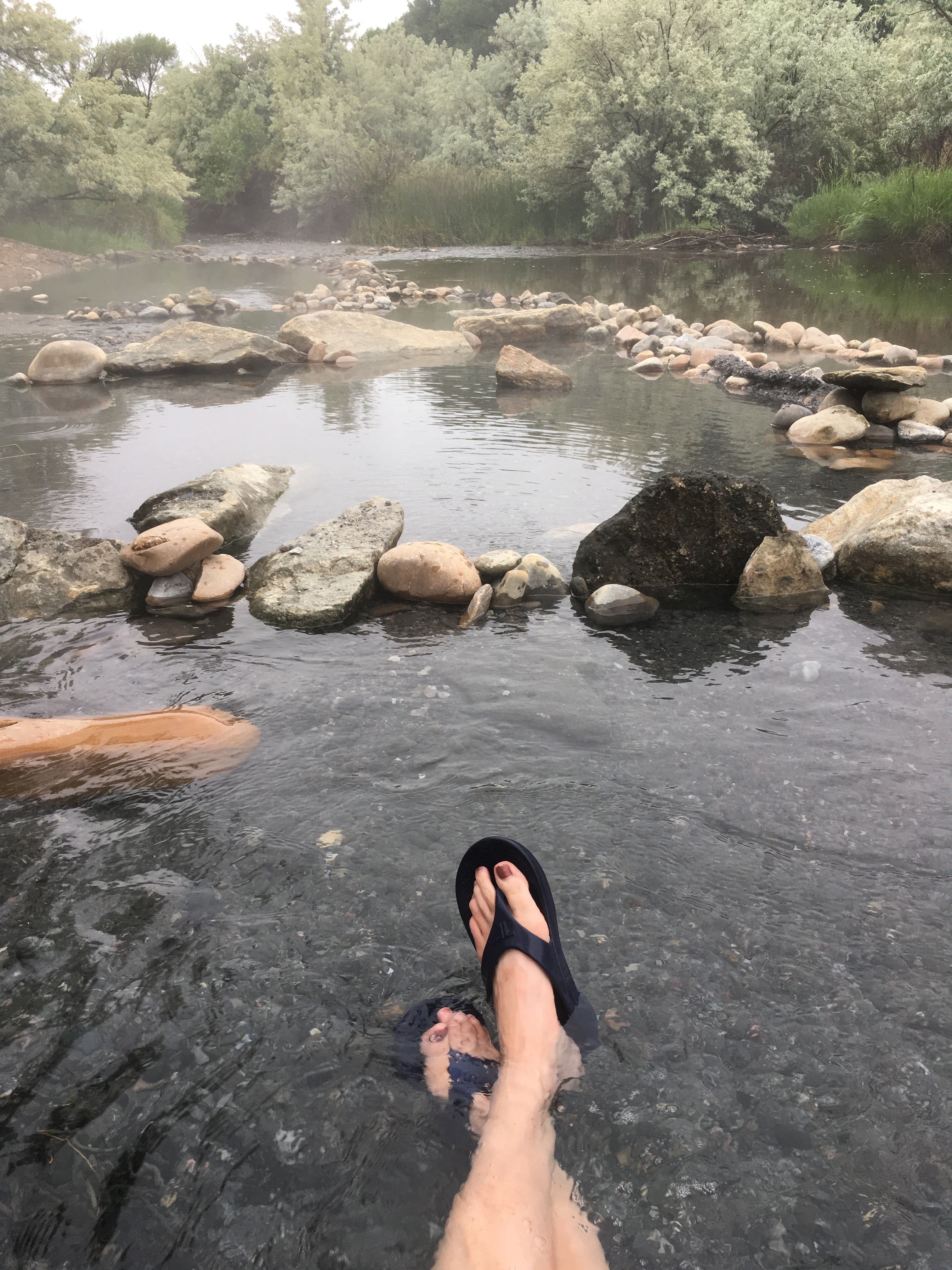 Sitting in the river where the hot springs water keeps things warm