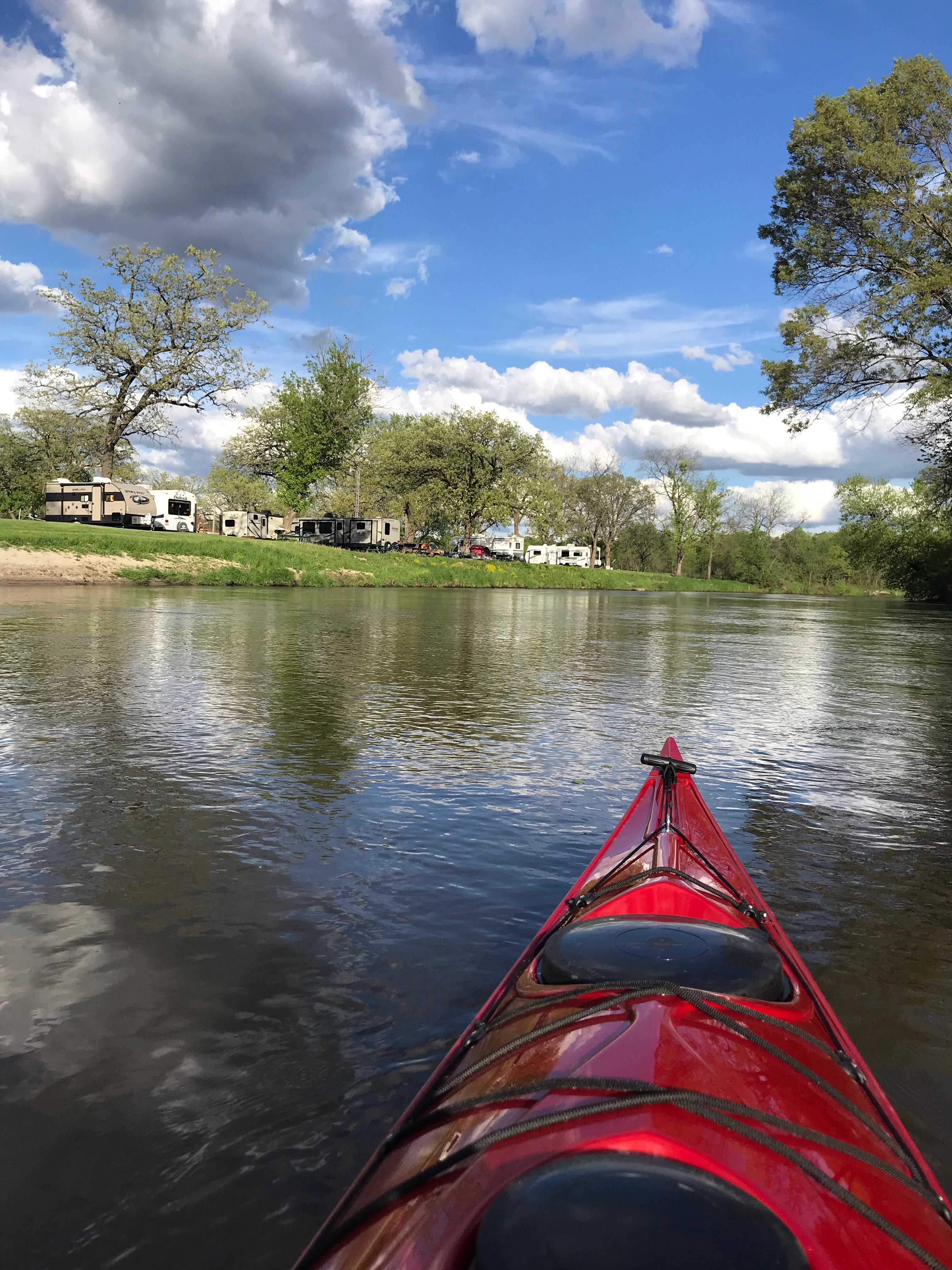 Kayaking past the campers on the river