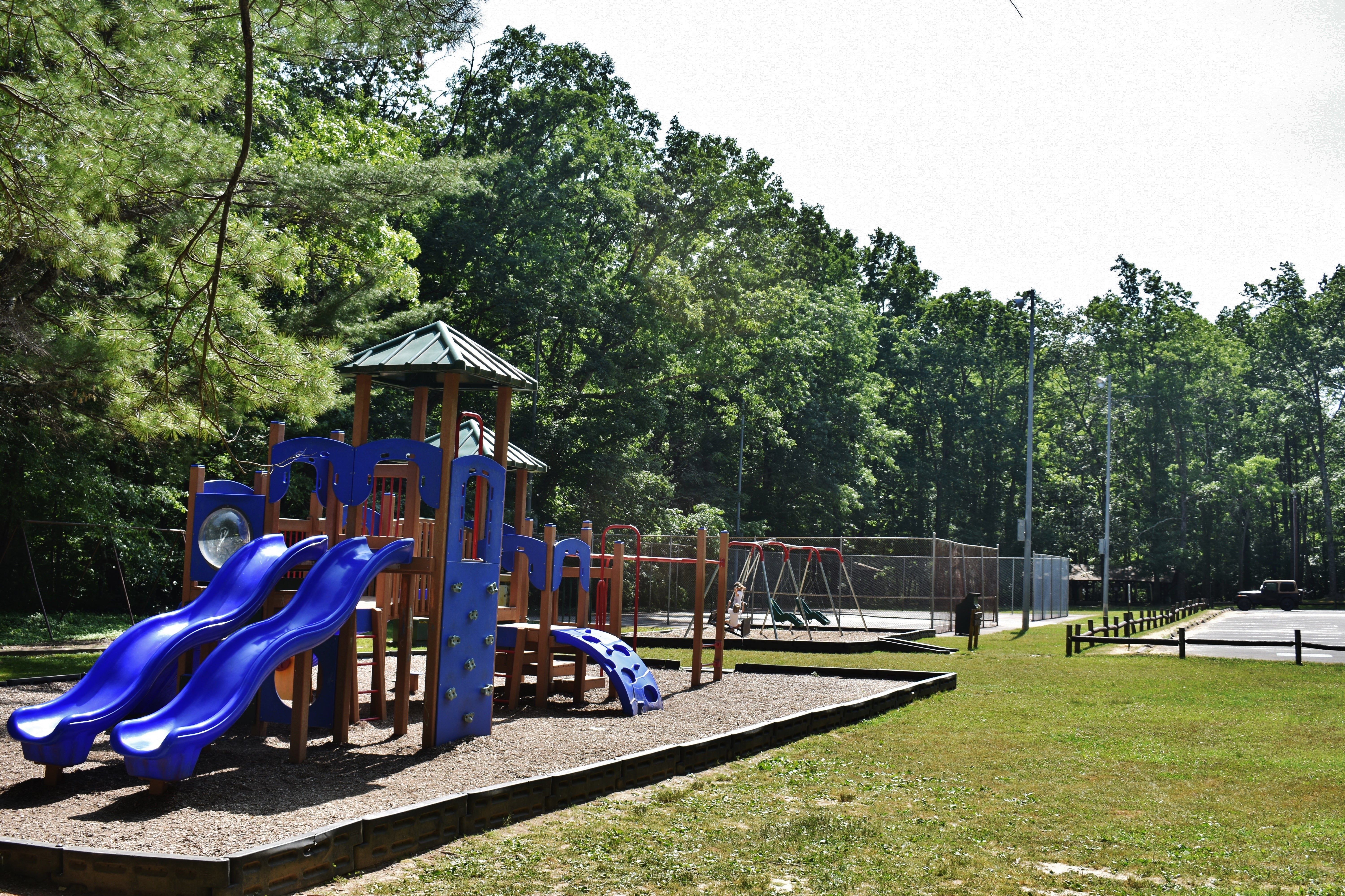 One area of the park has two play areas, tennis courts, and basketball.