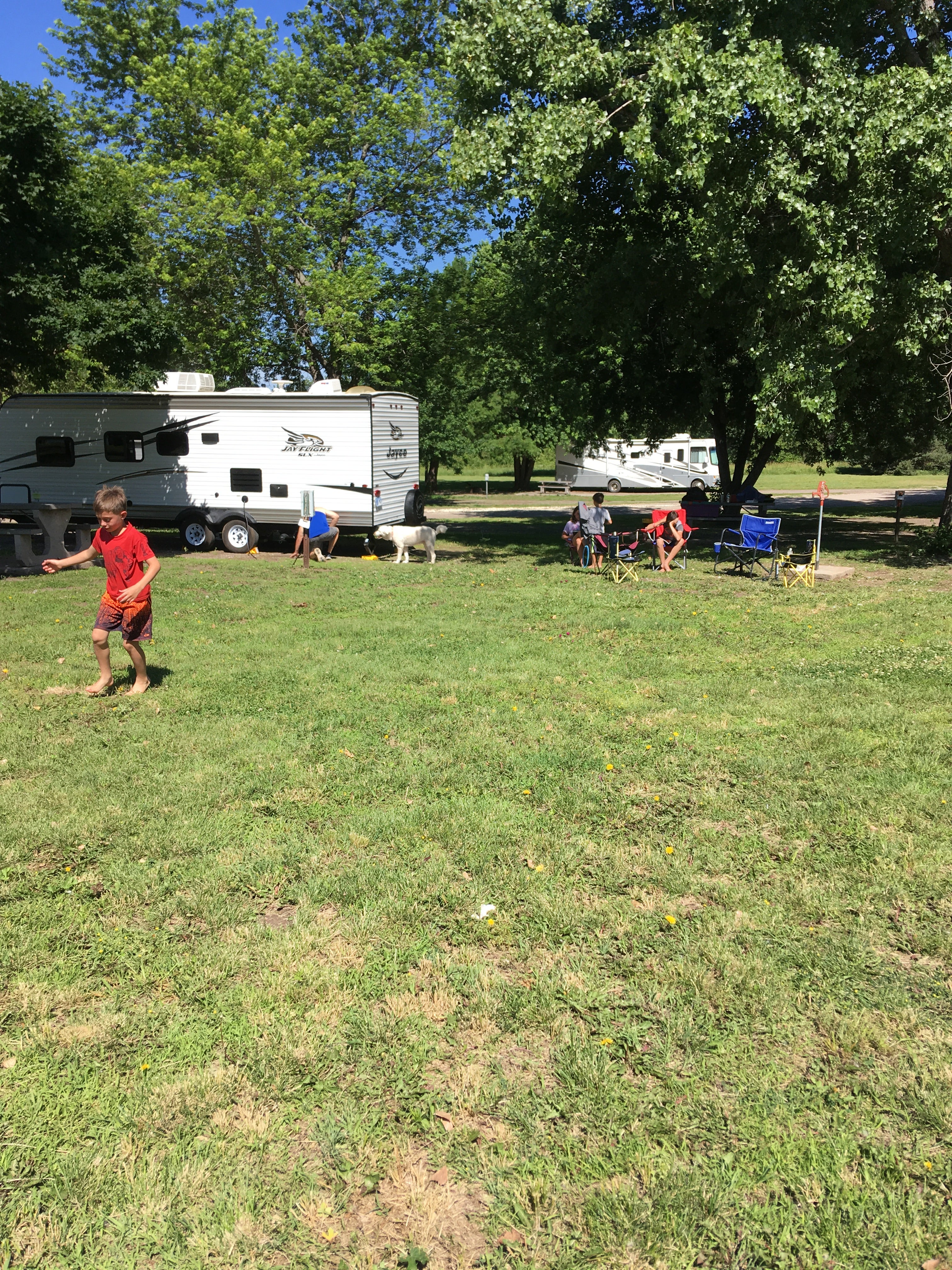 Clean camper area with grass to play on.