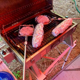 Hamburgers in the Grub Stick cages over the grill