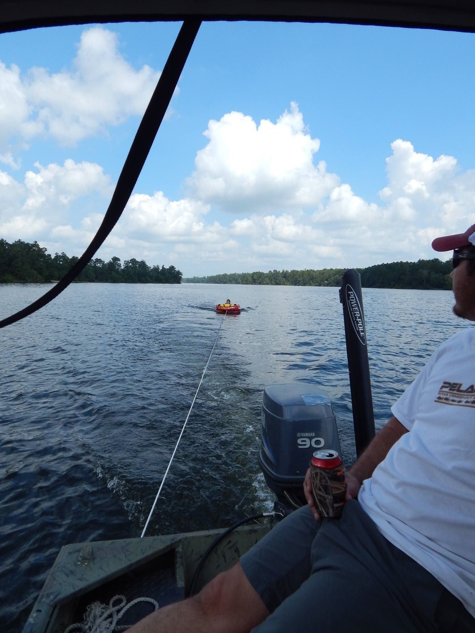Tubing behind boat in lake