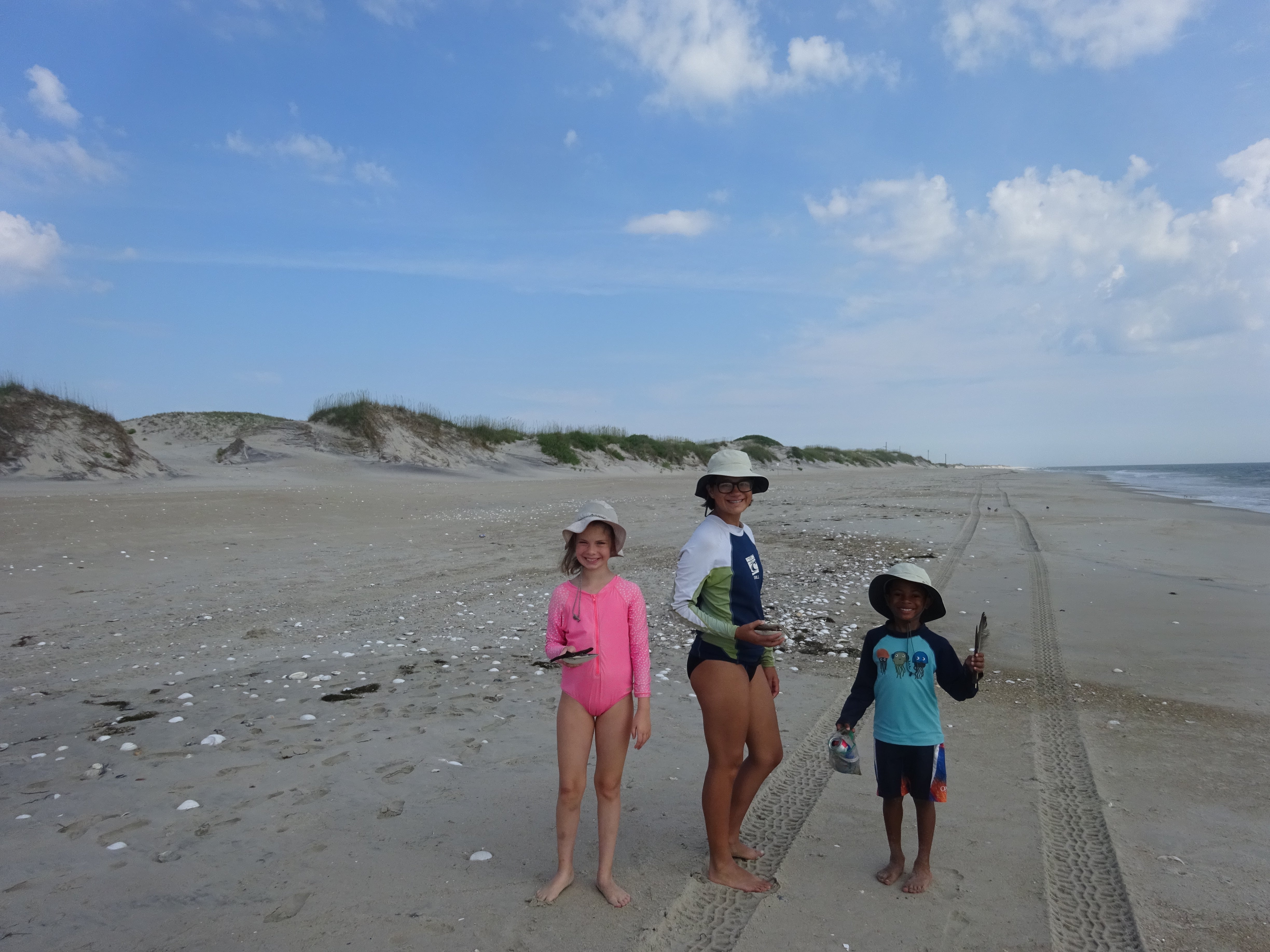 Kiddos finding shells on the beach - yes you can drive on the beach in certain areas here!