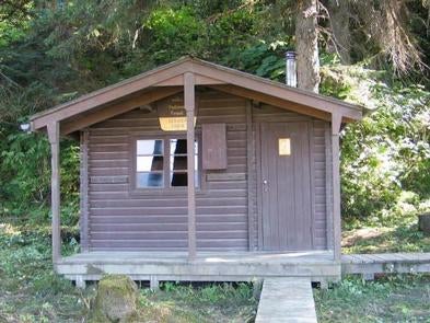 Sergief Island Cabin exterior brown wood cabin with greenery surrounding it



Sergief Island Cabin

Credit: USFS