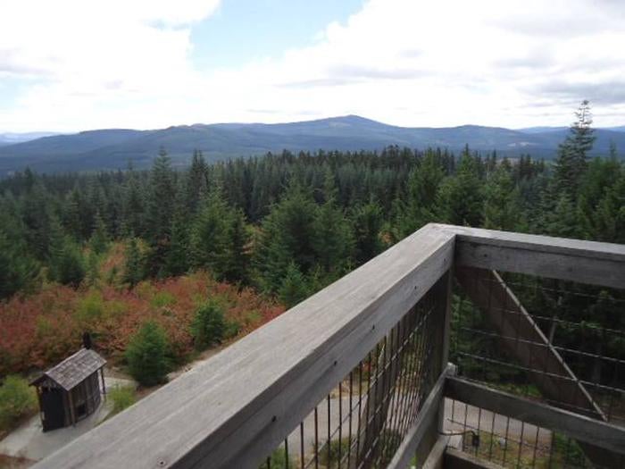 View from lookout deck over outhouse with mountains and forest in the background.



View from Clear Lake Cabin Lookout.

Credit: USFS