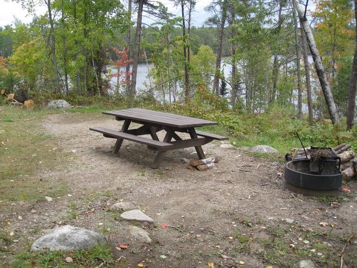 Picture of campsite with fire ring and table.



Typical campsite near the lake.  Most sites provide small parking spur with steps to access table, firegrate, and tent pad.

Credit: FS