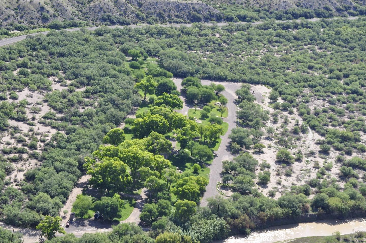 Aerial view of Cottonwood Campground, bright green trees amidst the low desert, riparian area



Aerial view of Cottonwood Campground

Credit: NPS