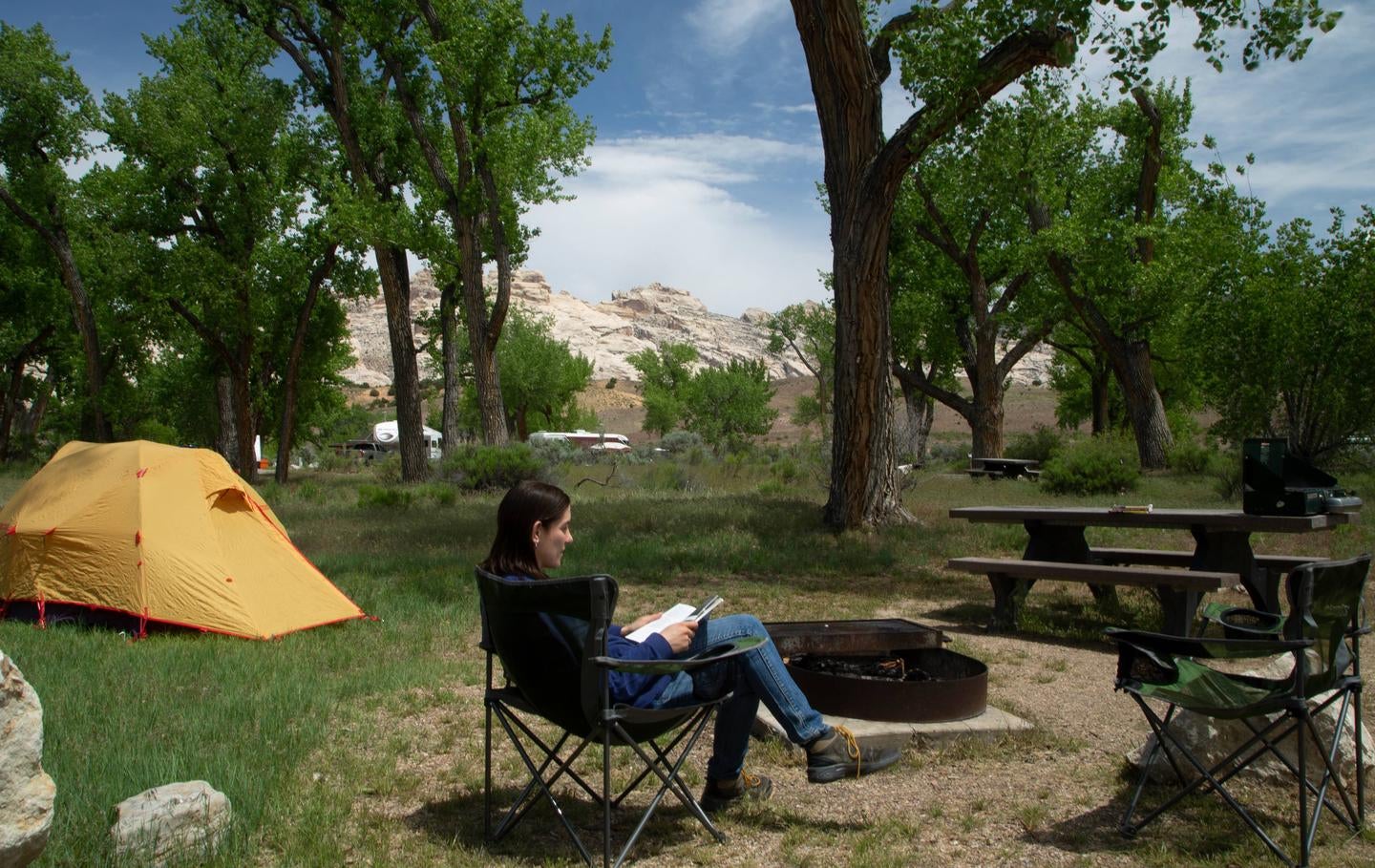 Camper in relaxing in camp chair in campsite. 



Credit: NPS