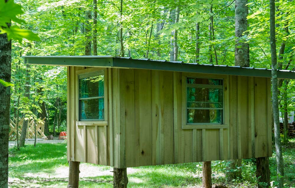 Cozy Camping Cottage has plenty of widows for cross ventilation and curtains for privacy