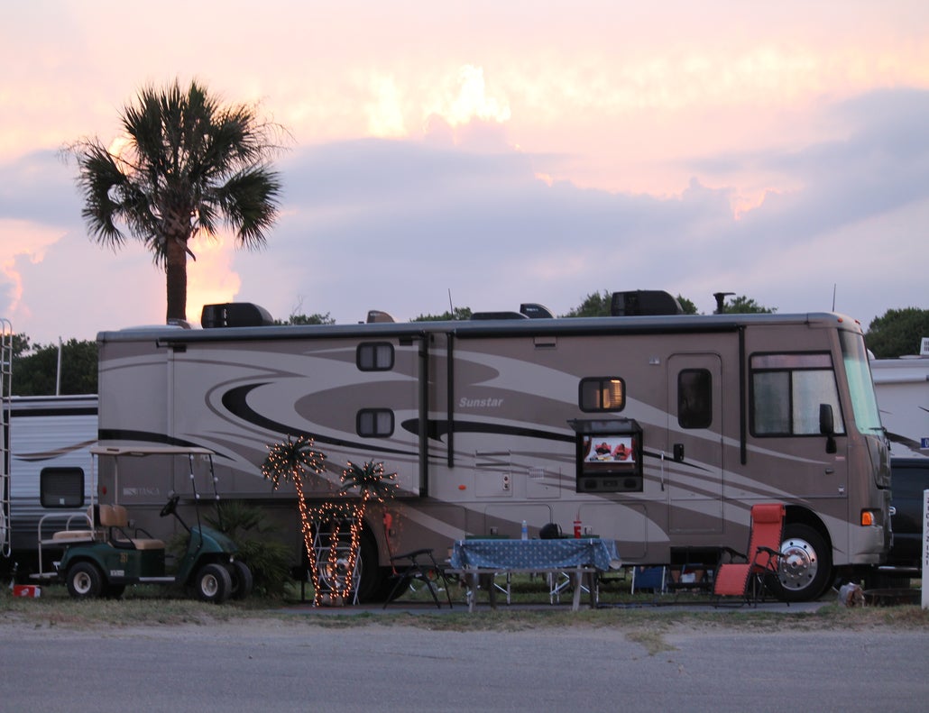myrtle beach camping at sunset with a palm tree in the background