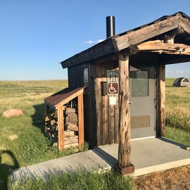 Vault toilets at the edge of each loop with firewood