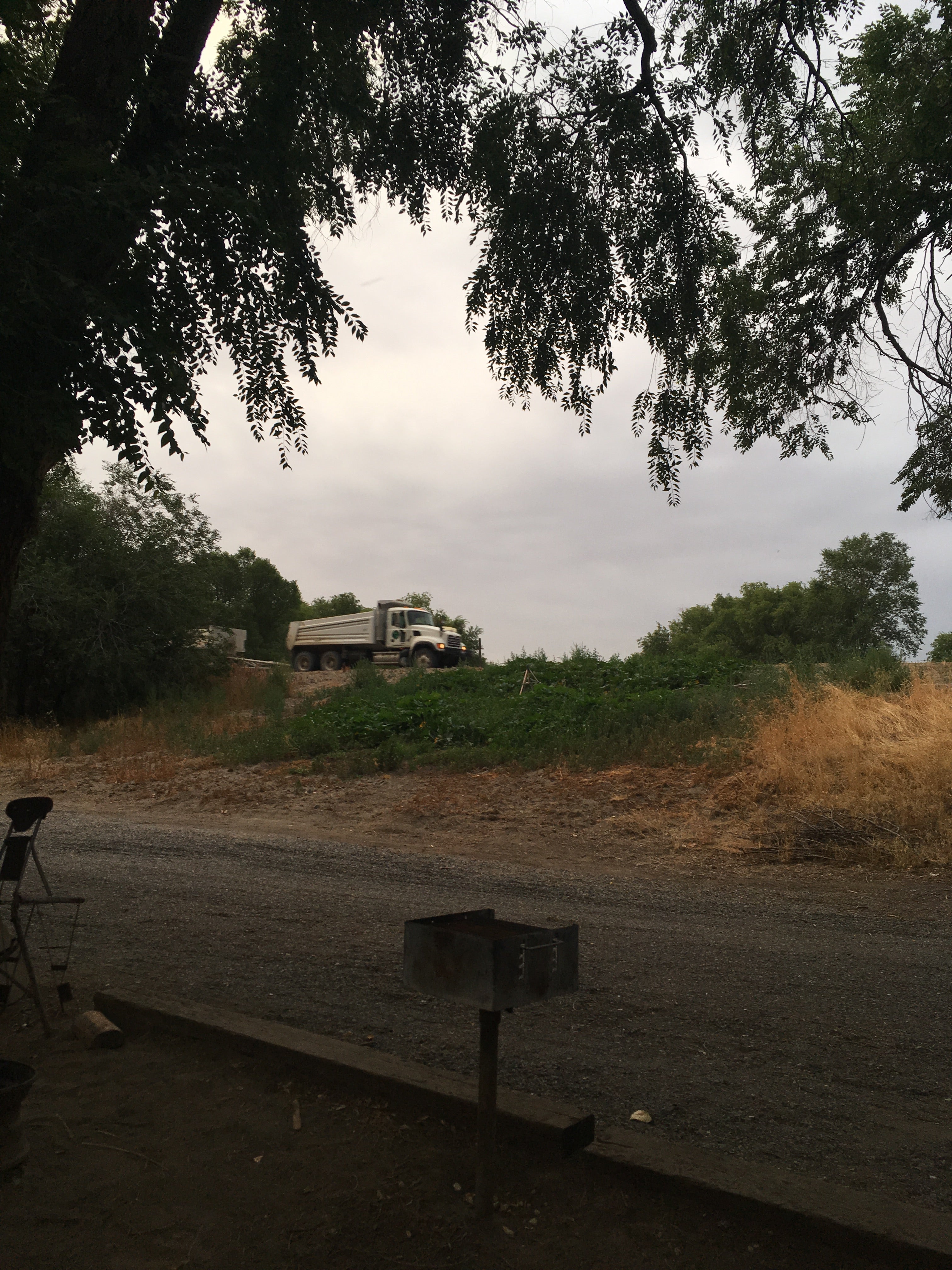Campsite fire grill + scenic truck in background