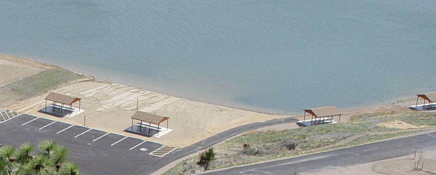 Beach/swimming area at BLM White Sandy Campground. 2 shade structures within the sandy beach area and 2 shade structures adjacent to the swimming area. These 4 shade structures are for day-use only.



BLM White Sandy Campground beach area.

Credit: BLM