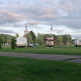 view from back of campground toward town. Hookups are on posts between two sites