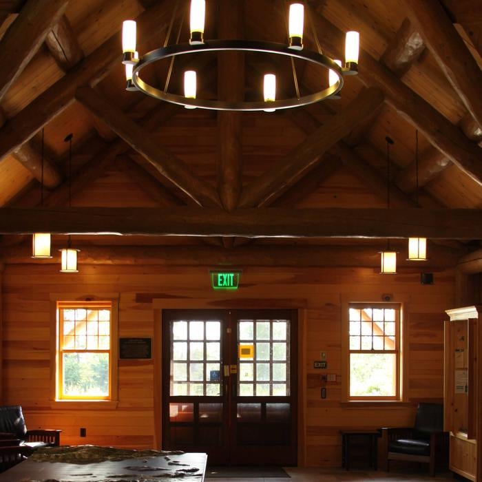 Interior of log cabin style ranger station with vaulted ceiling and large chandelier. 



Inside Schoodic Woods Ranger Station (Photo 1 of 2)

Credit: NPS