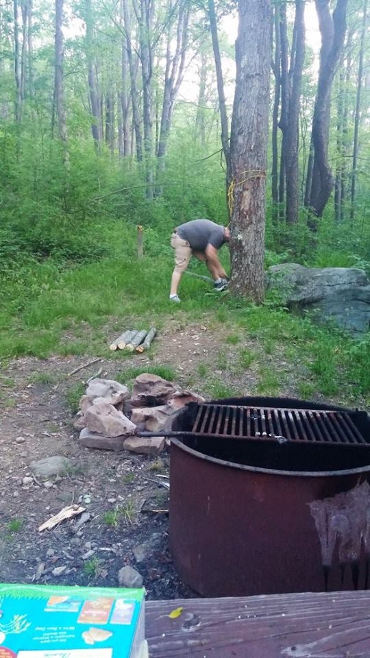 Cutting some firewood for the campfire.  All of the sites in the upper campground are surrounded by trees. 