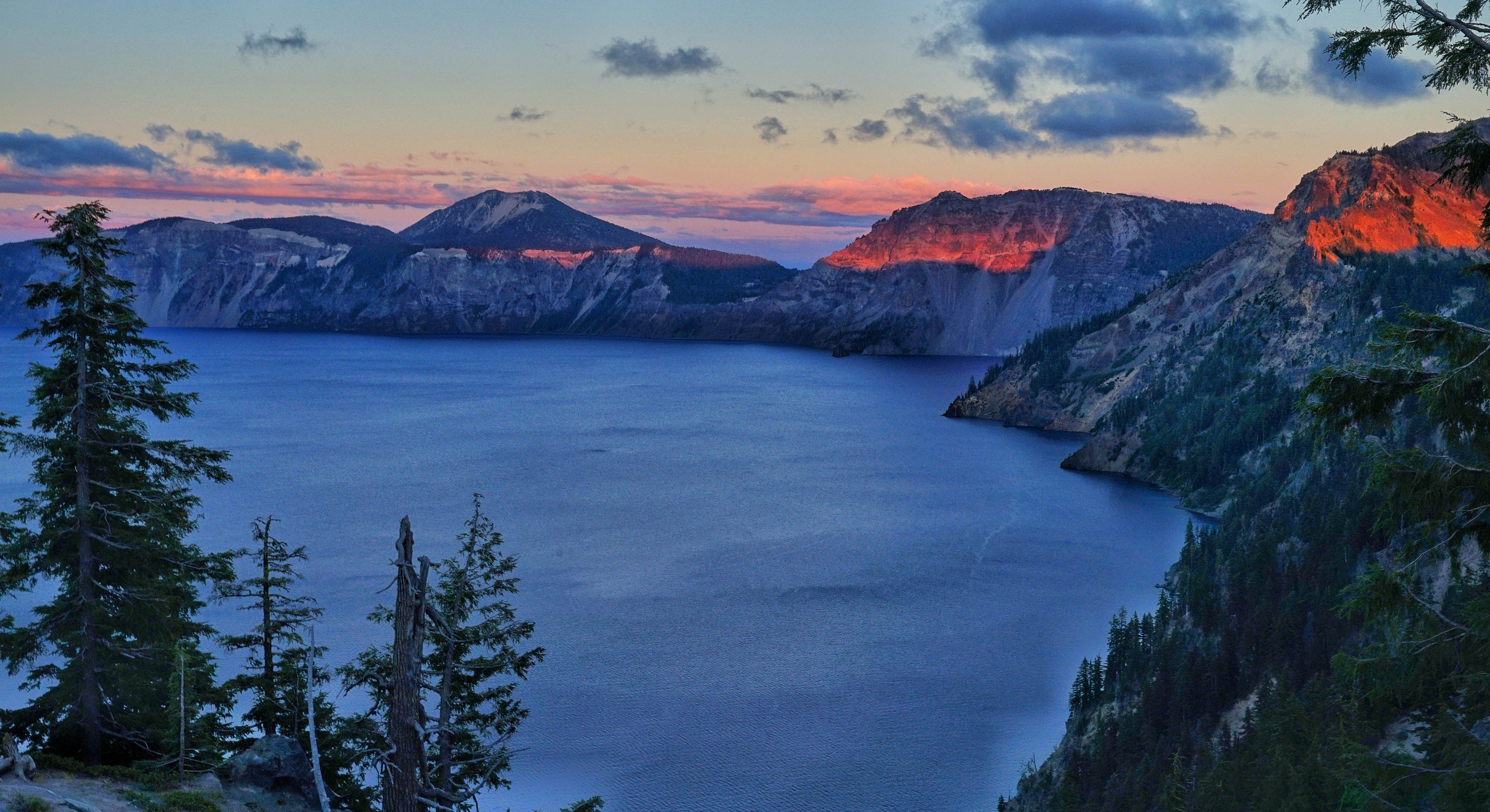 Sunset glow on Crater Lake's rim and forests
