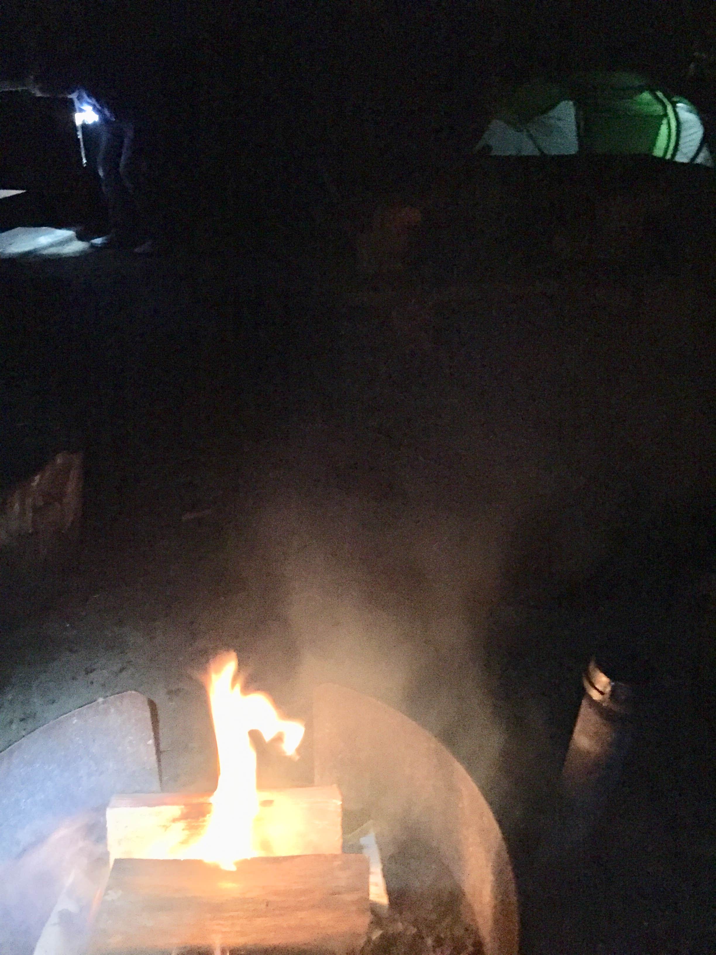 Trying to have a campfire at our flooded campsite just to keep warm. Not a happy visit.