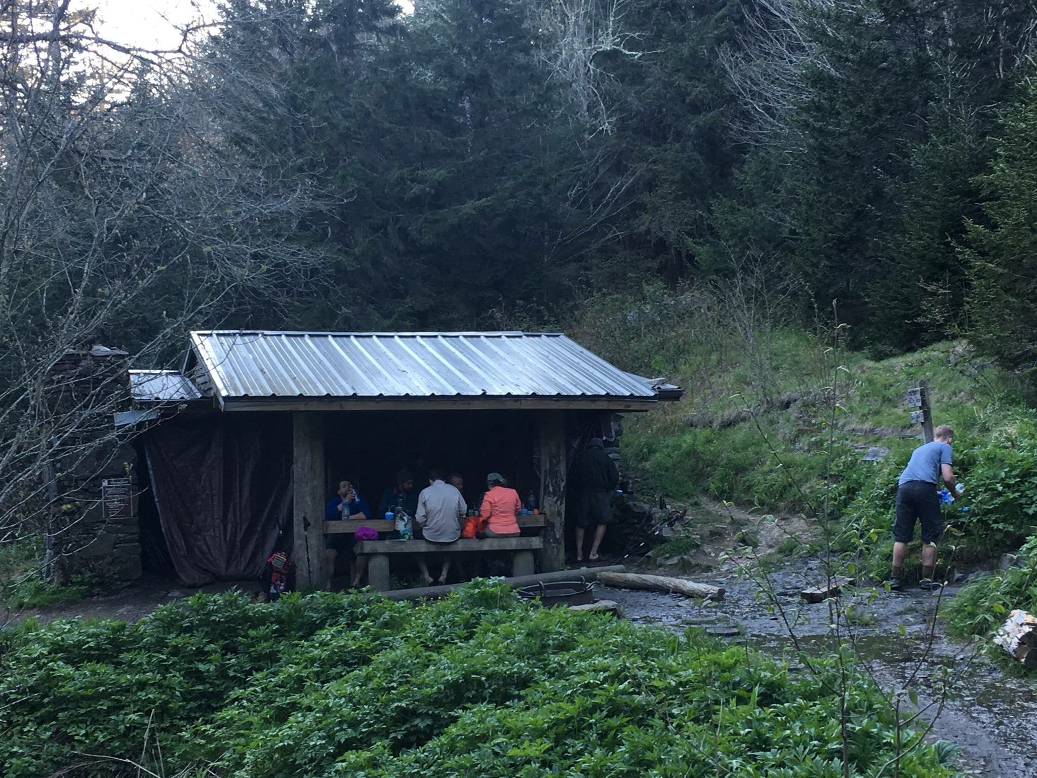 Tricorner Knob Shelter.  Guy on right is filtering water. 