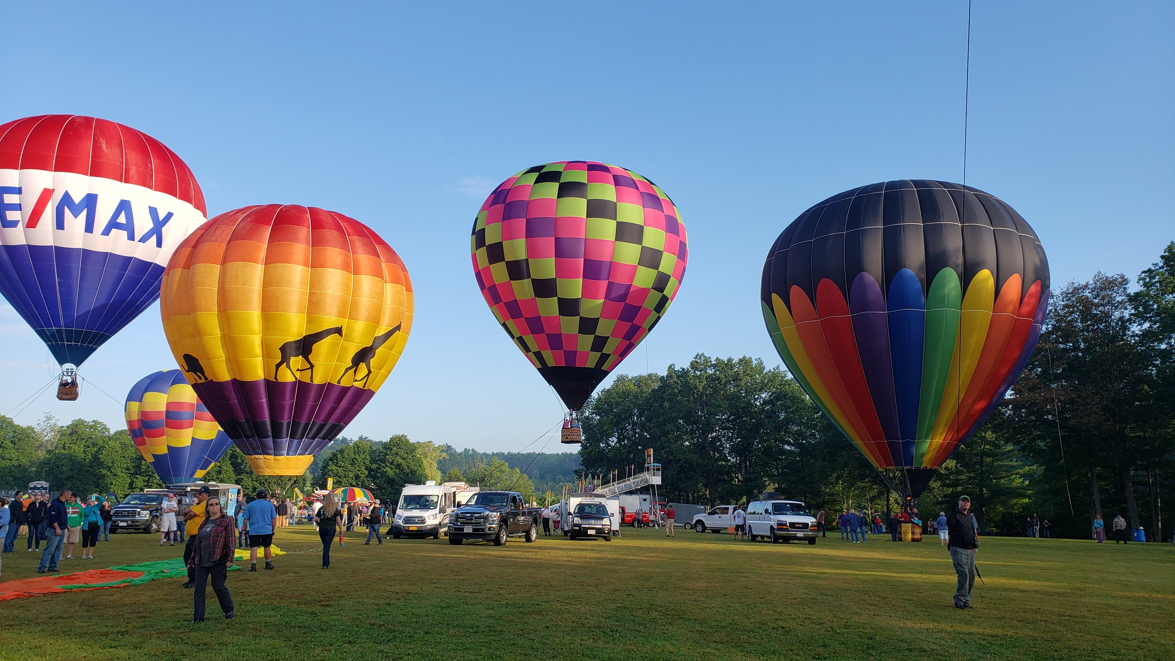 Suncook Valley Rotary Club Balloon Festival is nearby in early August. This morning it was too windy for takeoff, so they were staying tethered to the groun.