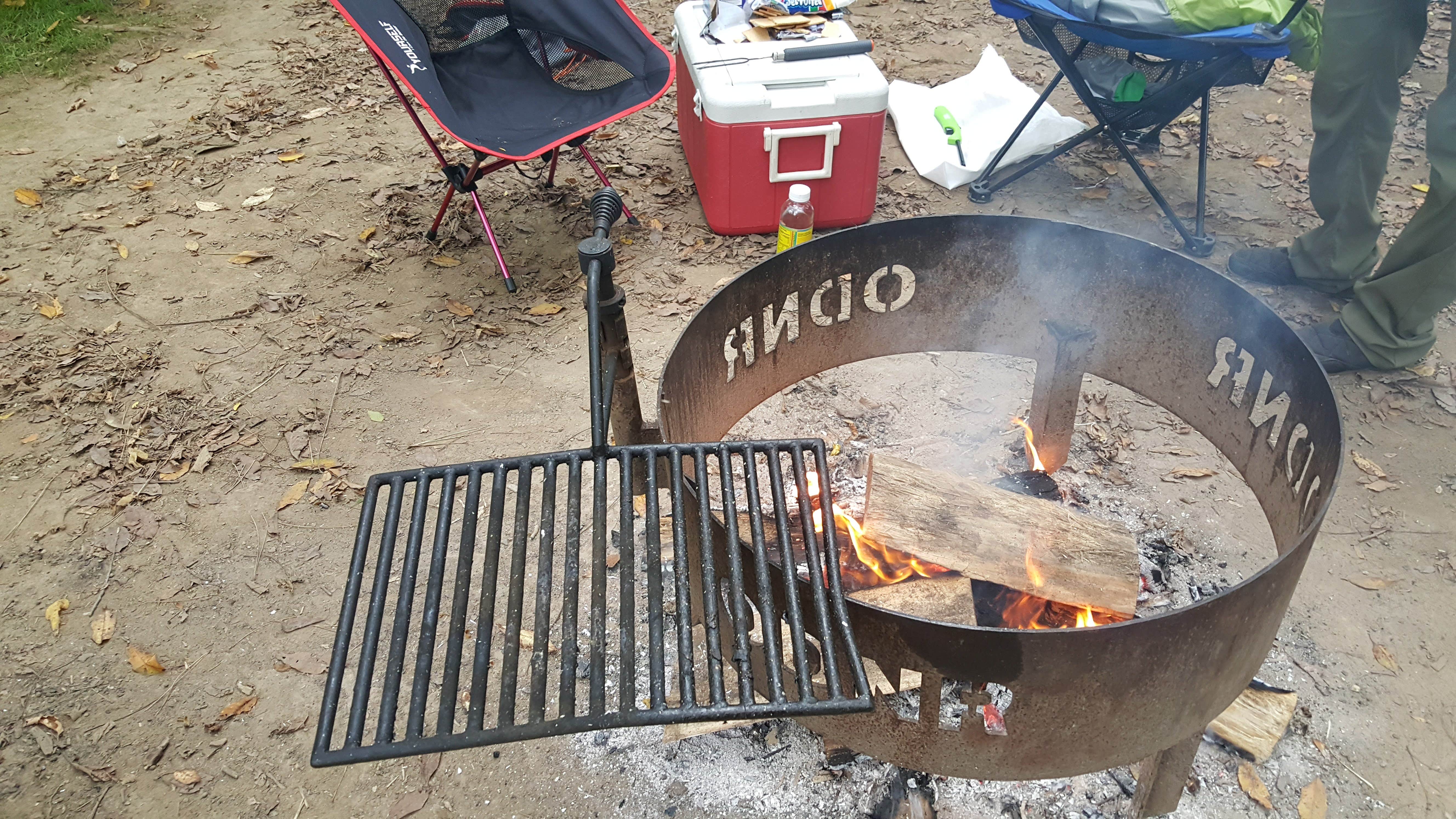 The fire ring has Ohio Department of Natural Resources on it but this one is unique as it also has a grill that can swing into the fire or out of the fire. It can also go up and down depending on how close you want it to the flames. A refreshing take on the camp fire grill that is provided in the parks.