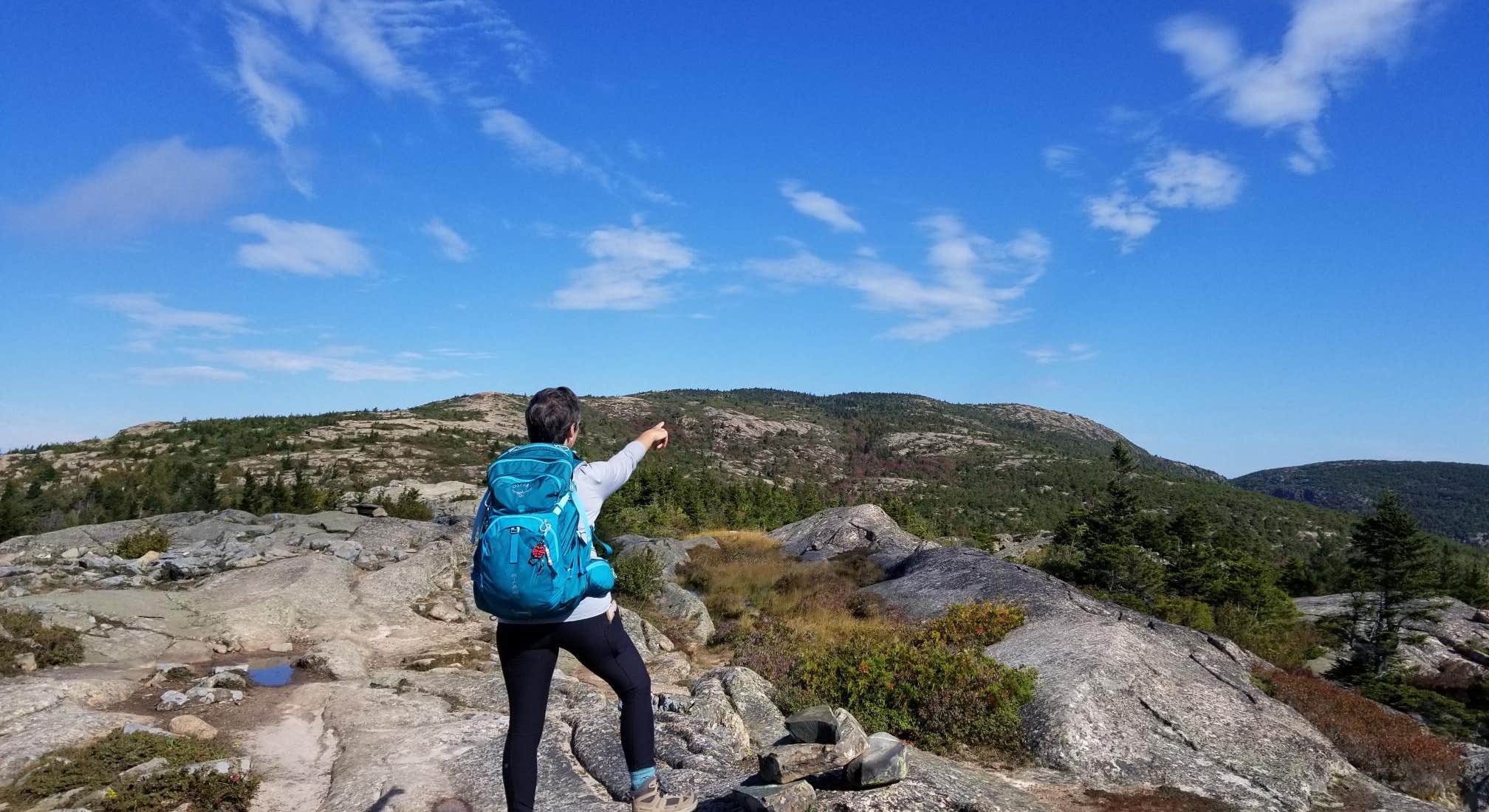 Hiker goind up Cadillac Mountain at Blackwoods Campground Acadia National Park