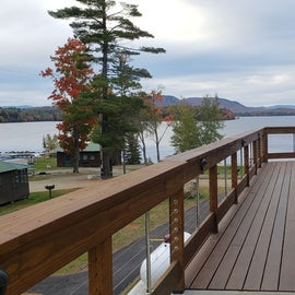 The bathhouse is a short walk from a parking are on the road, just before it descends toward the lake. Wrap around deck gives nice views of the lake. showers on this side, laundry close to the front of the building. Ramp leads to the back, steps from below.