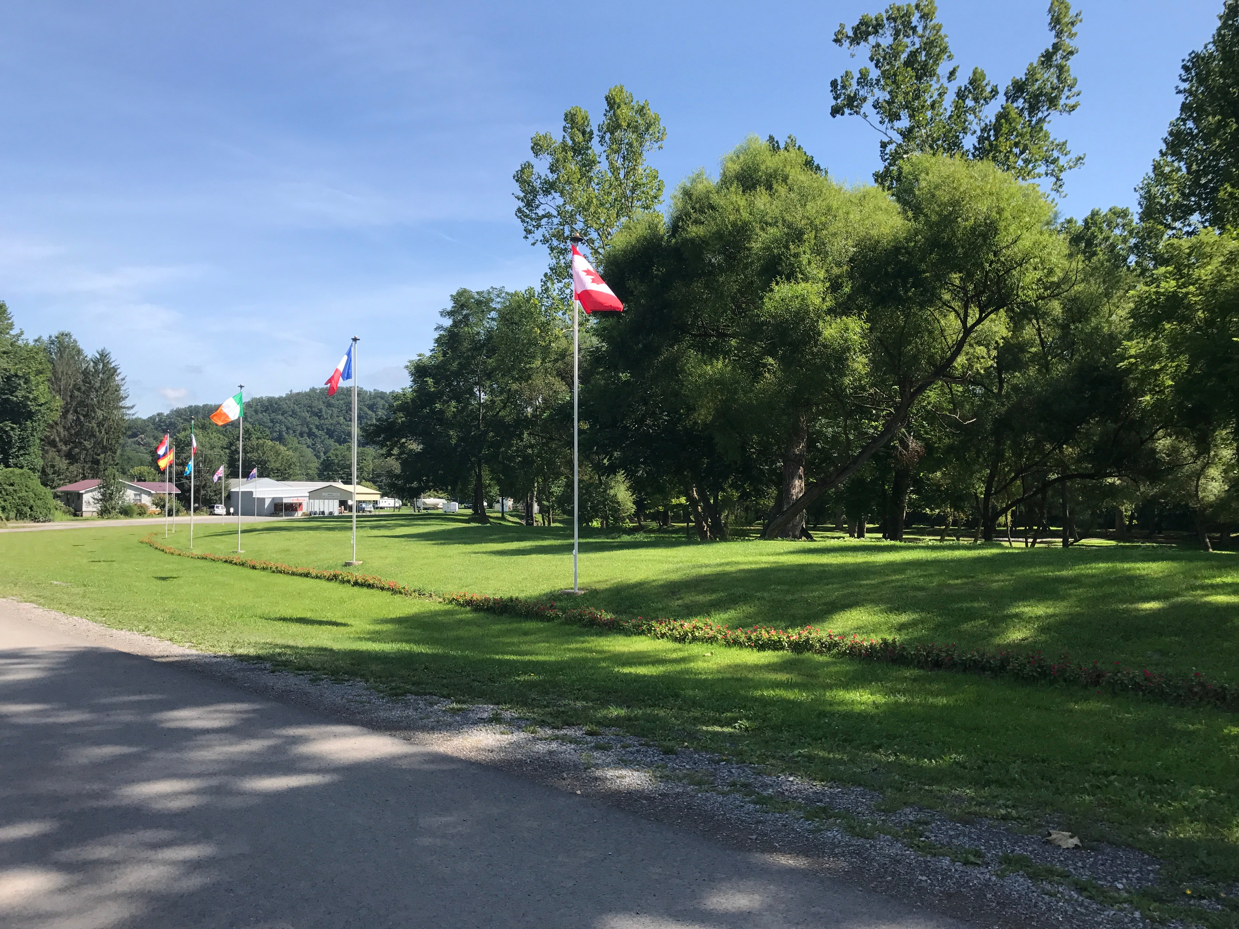 Campground entrance drive. Flags represent the different countries that attend the Bluegrass Festival.