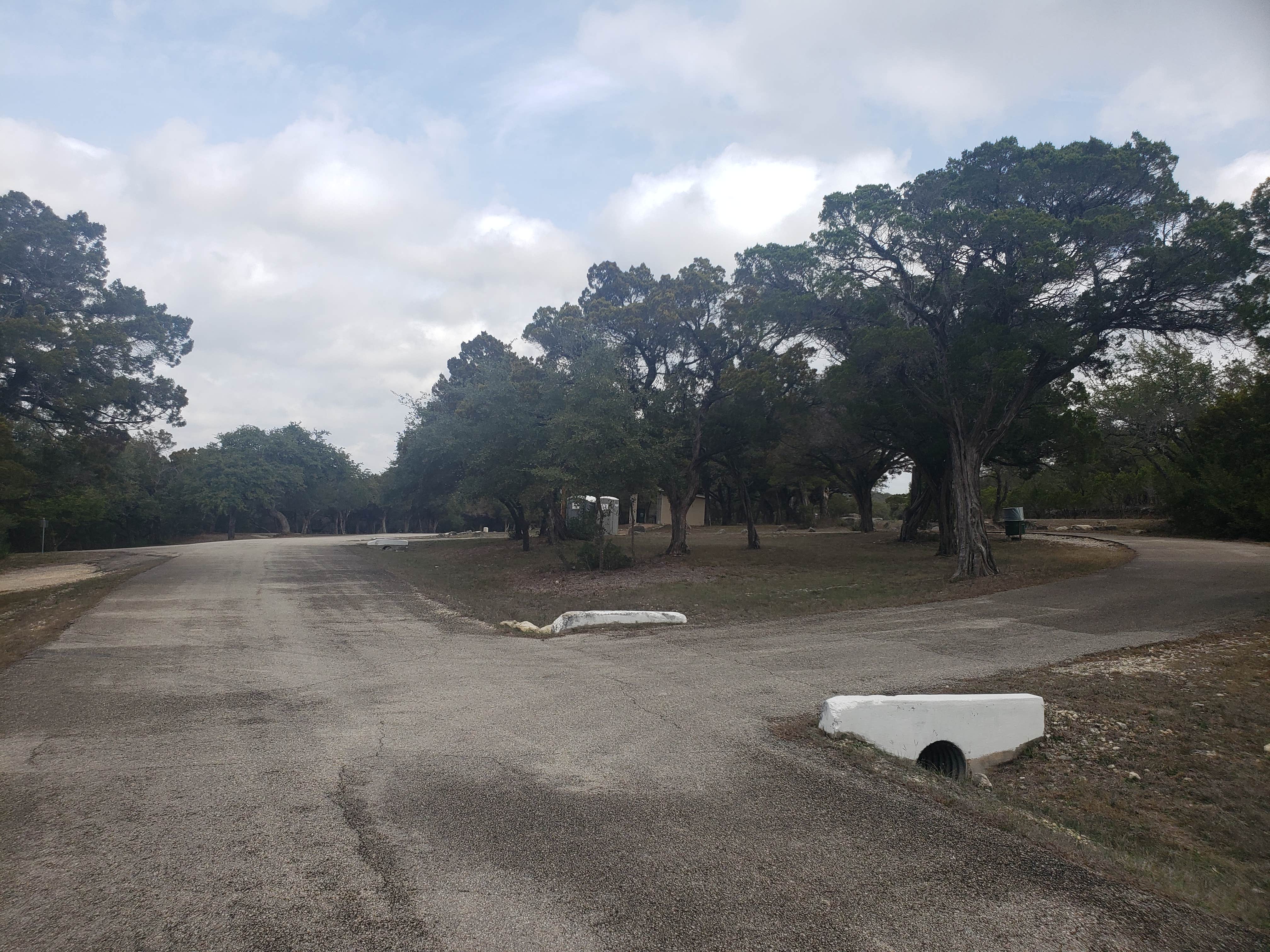 The narrower entrance to the dump station loop with the draining ditch and steep drop-off to the left side of the photo limiting your turn radius.
