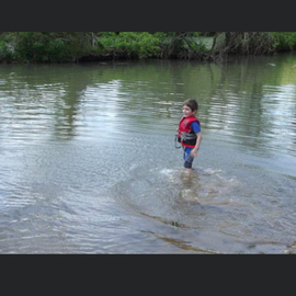 My youngest son playing in the river