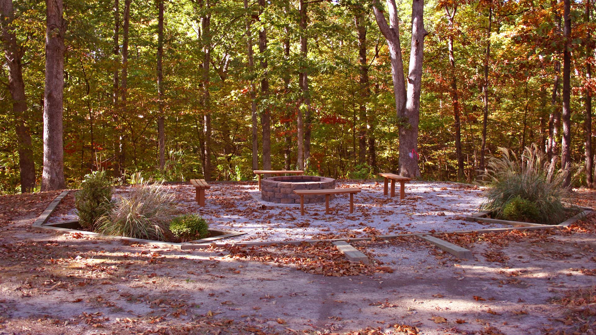 One of the deluxe sites in the year round part of Lone Point campground. This is behind the drive and standard grill, firepit, picnic table, lantern pole and steel pole mounted camp stove tray.