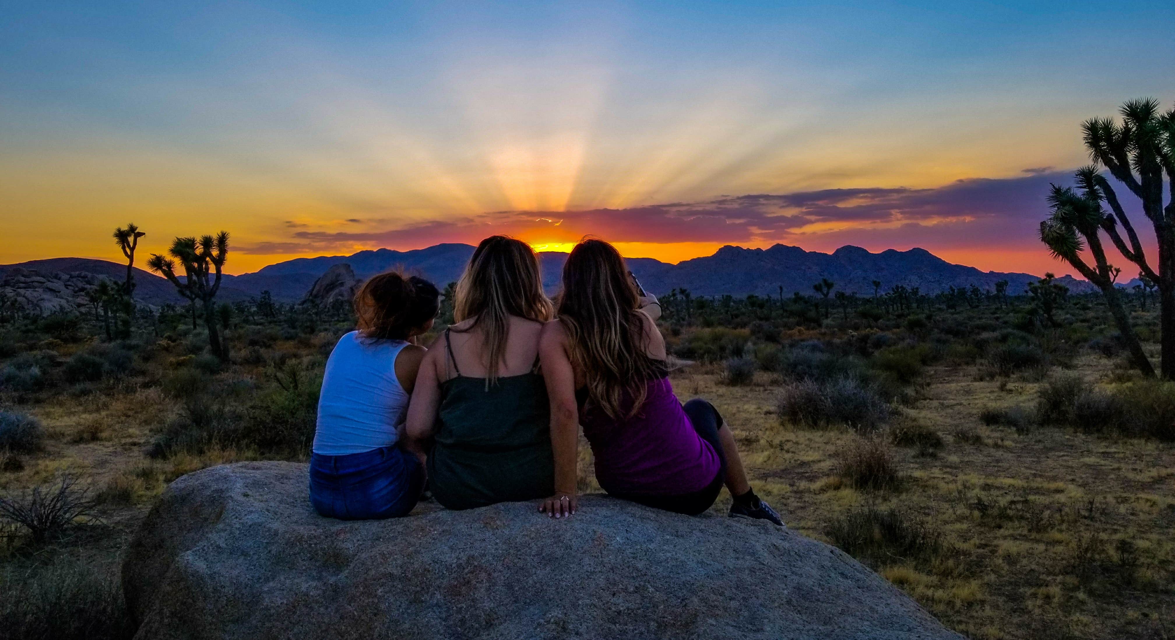 3 Girls Sitting on Large Rock at Sunset at Jumbo Rocks Campground Joshua Tree National Park