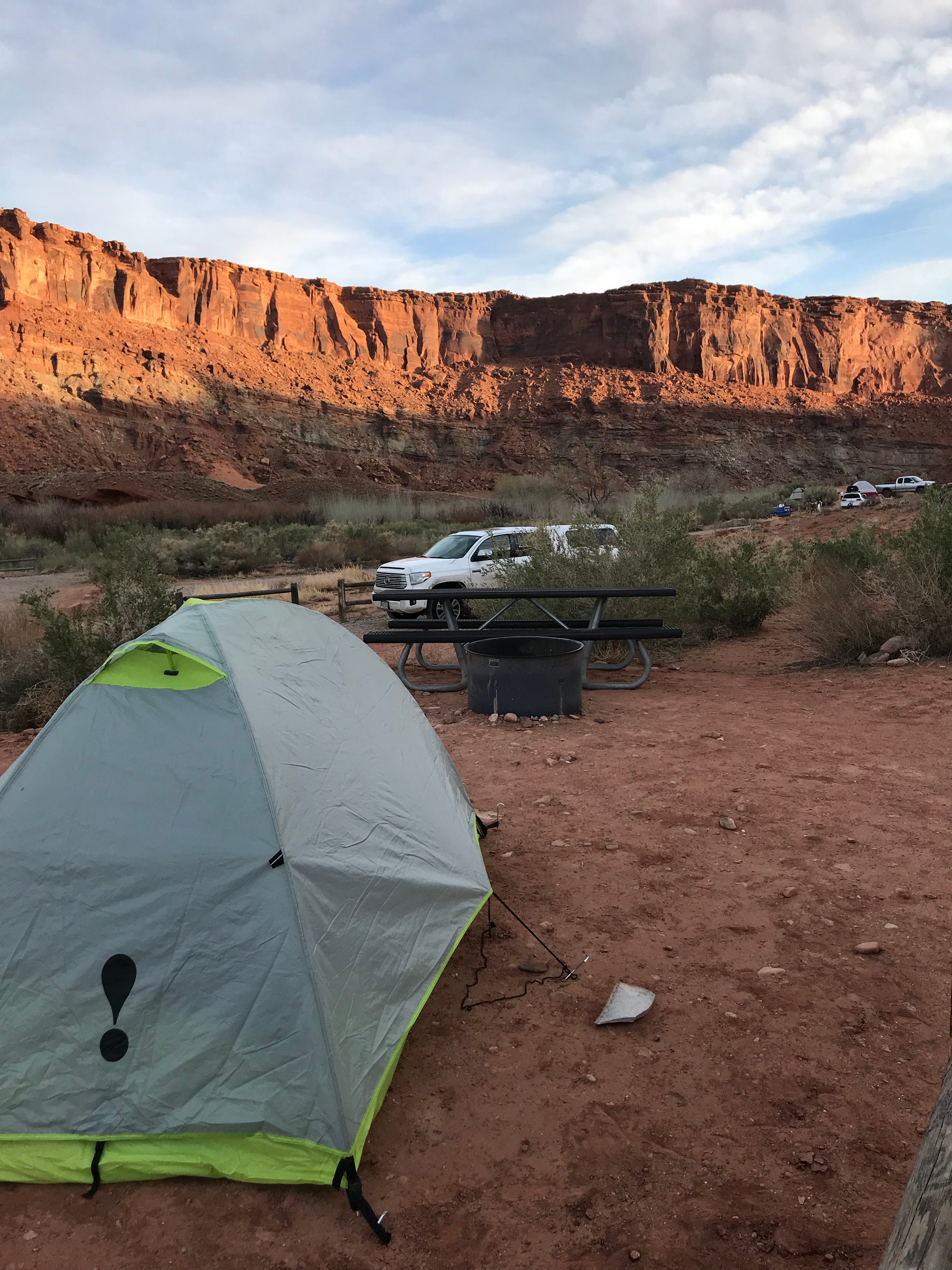Beautiful red cliffs surround the campground. Photo shows the picnic tables and fire rings well