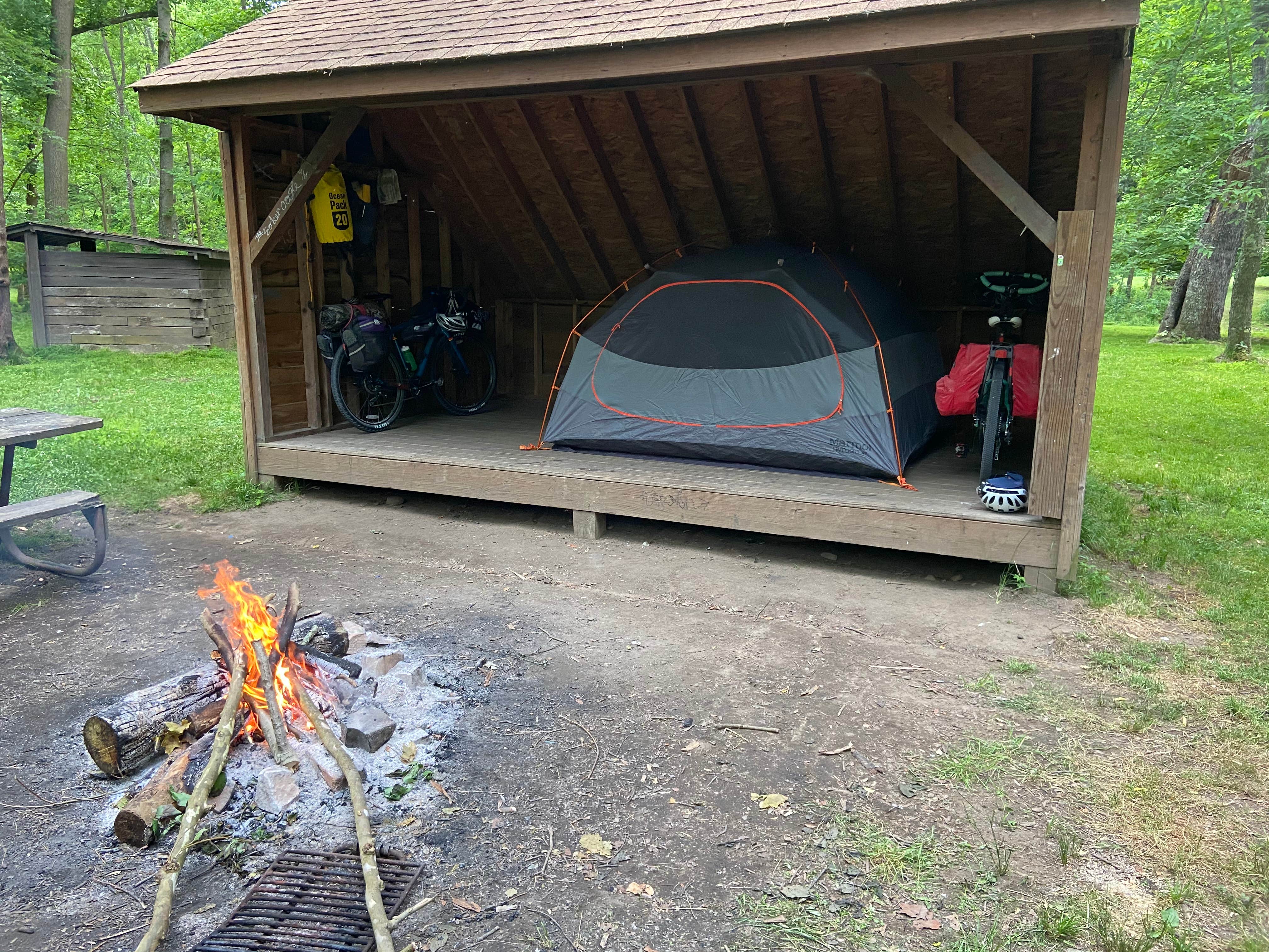 Tent and bikes in the shelter with impending rain