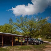 Bunkhouse with porch swings, ceiling fans, picnic tables, grill and fire ring