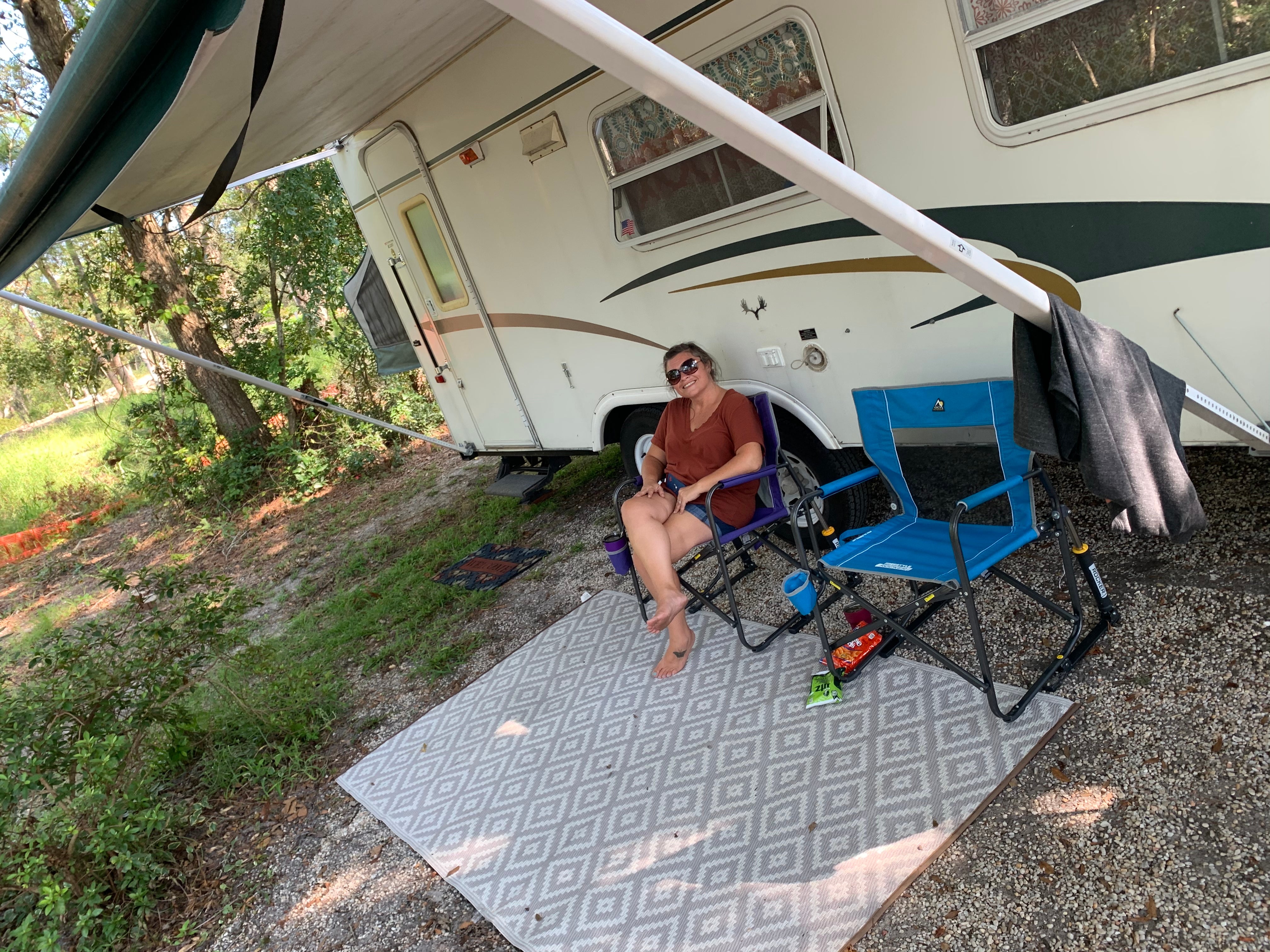 My beautiful wife relaxing outside of our camper!