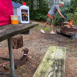 Our tent is in the background. There are three lantern post at this site. The grill area combo combines a fold down grill with the outer edge for the fire ring.