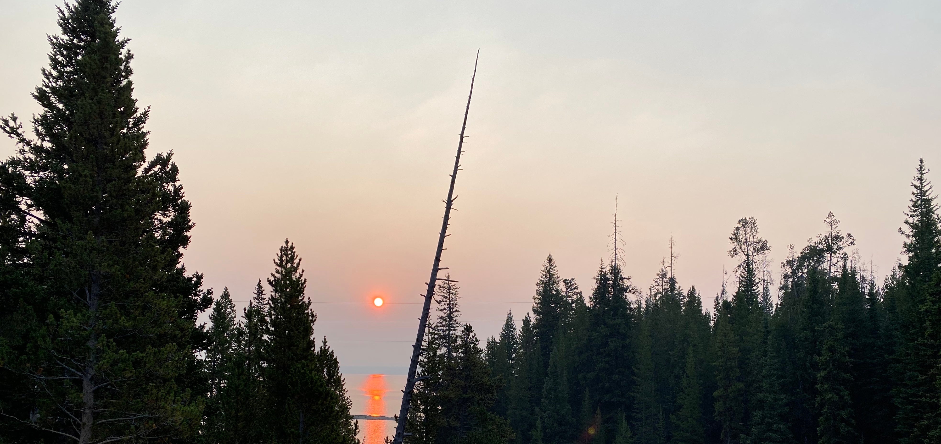 Hazy sunrise on Yellowstone lake from the bridge on campground road